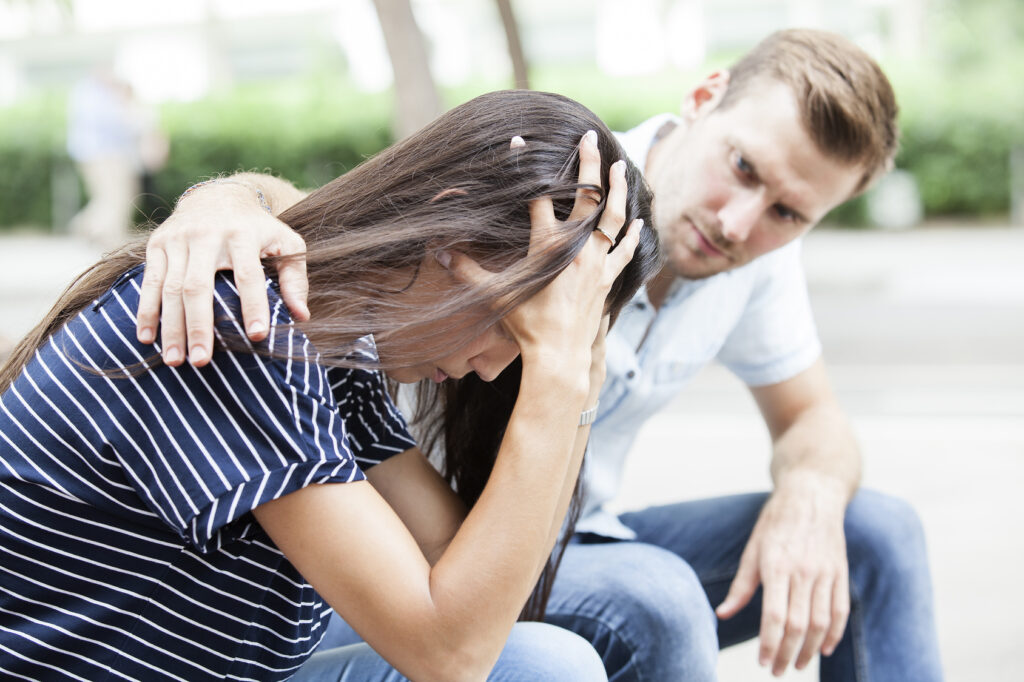 Man comforting his sad mourning friend 2