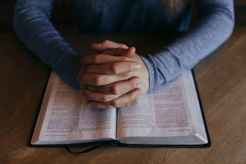 Religious Person's Hands on Bible