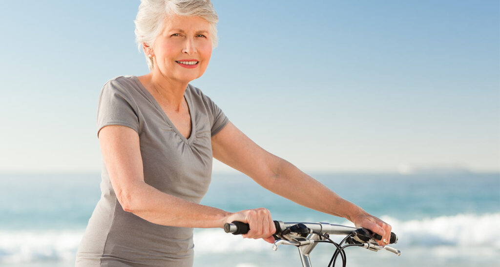 Old Woman on Bike Near Ocean (not cropped)