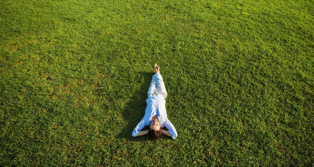 Person Lying Relaxed on Grass