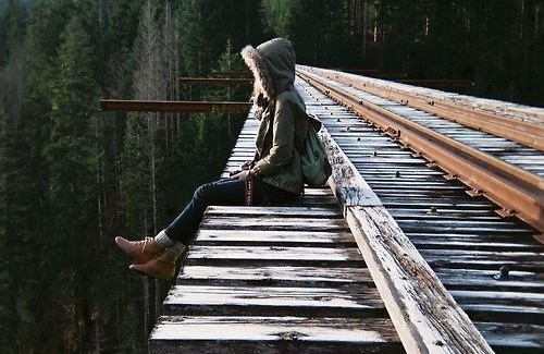 Girl Contemplating Suicide Sitting on Bridge